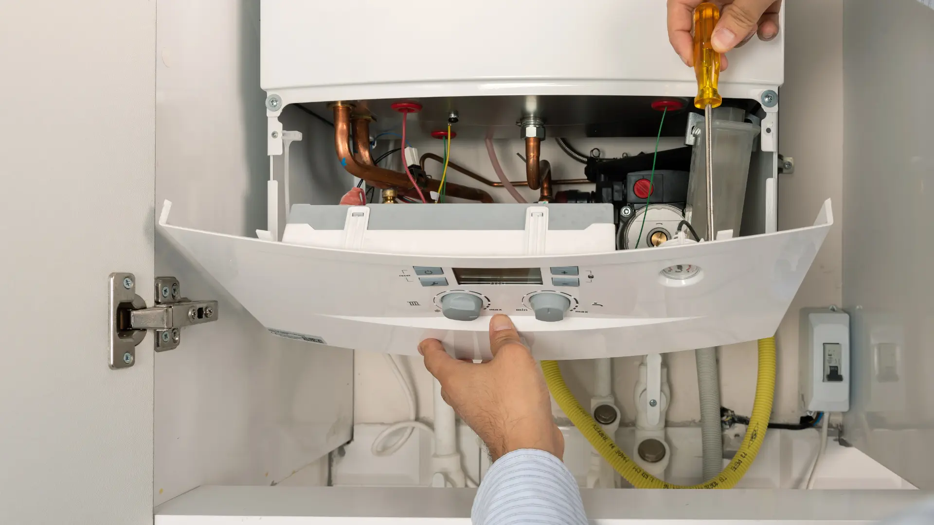 Gas Safe engineer diagnosing internal boiler components during a repair